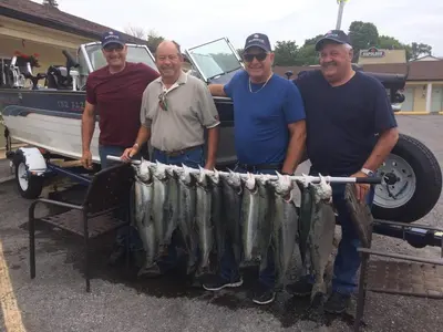 a group of four men holding a large haul of fish at Budget Inn in Port Hope