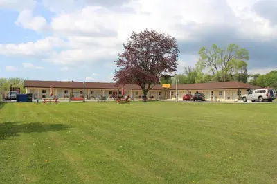 a large grass field in front of a building at Budget Inn in Port Hope