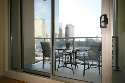 a balcony with a table and chairs on a balcony at Yonge Suites Apart Hotel in Toronto