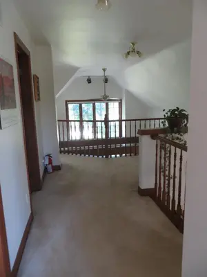 an empty hallway with a staircase in a house at Cedar Gables Bed & Breakfast in Niagara on the Lake