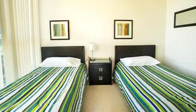 two beds sitting next to each other in a room at Pathway Suites in Mississauga