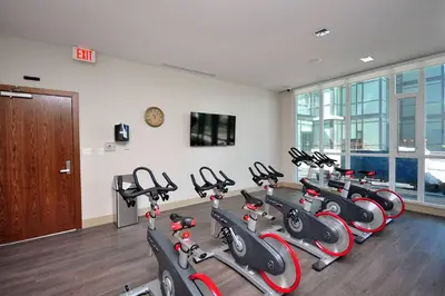 a gym with a bunch of exercise bikes in a room at Pathway Suites in Mississauga