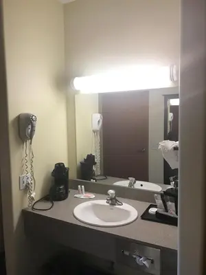 a bathroom with a sink and a mirror at Super 8 by Wyndham Barrie South in Barrie