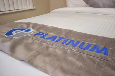 a bed with a mattress with the platynum logo on it at Platinum Suites Furnished Executive Suites in Mississauga