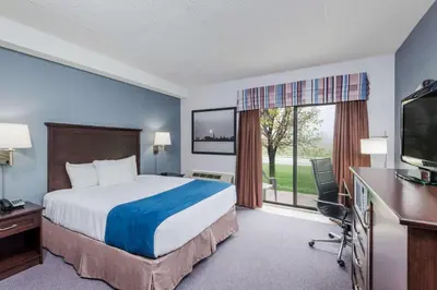 a hotel room with a bed and a television at Super 8 by Wyndham Port Elgin in Port Elgin