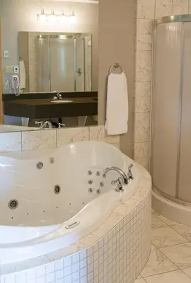 a large bathroom with a tub and a shower at Super 8 by Wyndham Port Elgin in Port Elgin