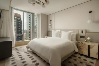 a bedroom with a large white bed and large windows at Four Seasons Hotel Toronto in Toronto