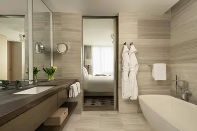 a bathroom with a tub and a sink and a bath tub at Four Seasons Hotel Toronto in Toronto