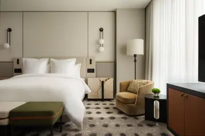a hotel room with a bed and a chair at Four Seasons Hotel Toronto in Toronto