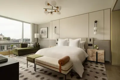 a bedroom with a large white bed and a couch at Four Seasons Hotel Toronto in Toronto