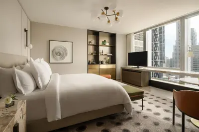 a bedroom with a bed and a desk and a television at Four Seasons Hotel Toronto in Toronto