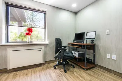 an office with a desk with a computer and a window at Comfort Inn in Owen Sound