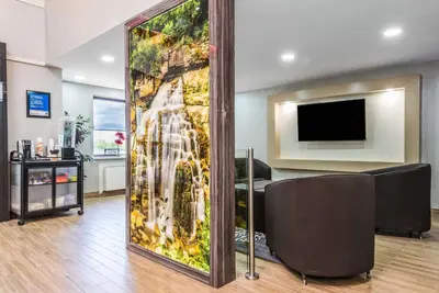 a living room with a wall with a waterfall at Comfort Inn in Owen Sound