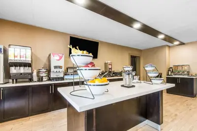 a buffet line with bowls of food on a counter at Comfort Inn in Owen Sound
