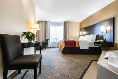 a hotel room with a bed and a desk at Comfort Inn in Owen Sound