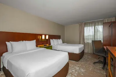 a hotel room with two beds and a desk at Comfort Inn in Cambridge