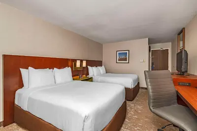 a hotel room with two beds and a television at Comfort Inn in Cambridge