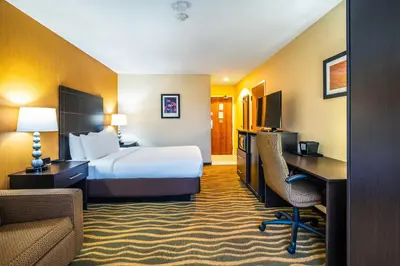 a hotel room with a bed and a desk at Quality Inn in Barrie