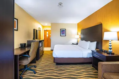 a hotel room with a bed and a desk at Quality Inn in Barrie