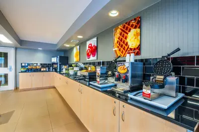 a restaurant with a counter with food on it at Quality Inn in Barrie