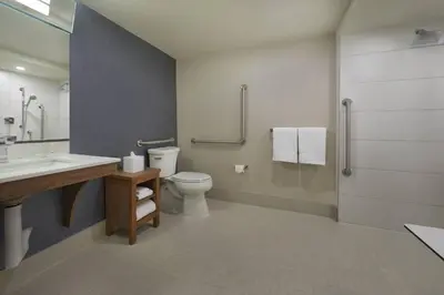 a bathroom with a toilet and a sink and a shower at Courtyard by Marriott Oshawa in Oshawa
