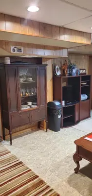 a large wooden cabinet in a room with a table at Private Apartment Close to Airport Toronto Pearson in Toronto