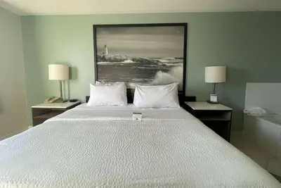 a large bed in a hotel room with two lamps at Super 8 by Wyndham Peterborough in Peterborough