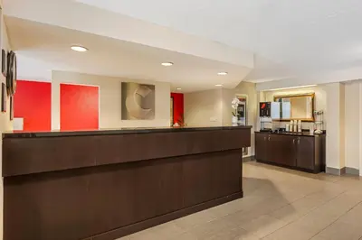 a hotel lobby with a reception desk and a kitchen at Comfort Inn in Brantford