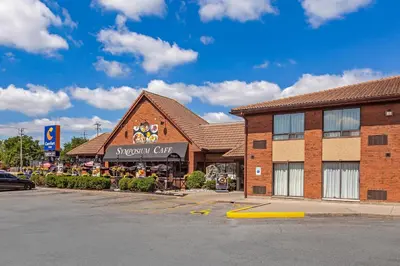 a shopping center with a snowomy cafe in a parking lot at Comfort Inn in Brantford