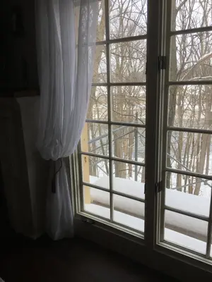 an open window with snow outside of it at The Carriage House Flat - Downtown Paris Canada in Paris