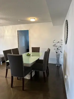 a dining room with a table and chairs at Toronto Downtown Luxurious Stylish 3 Bedroom 3 Bath 2 Balconies near Rogers Centre lakeview condo in Toronto