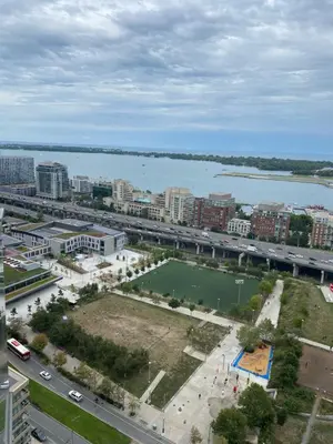 an aerial view of a city with a body of water at Toronto Downtown Luxurious Stylish 3 Bedroom 3 Bath 2 Balconies near Rogers Centre lakeview condo in Toronto