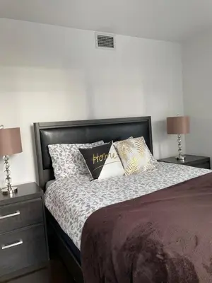 a bedroom with a bed with pillows and two lamps at Toronto Downtown Luxurious Stylish 3 Bedroom 3 Bath 2 Balconies near Rogers Centre lakeview condo in Toronto