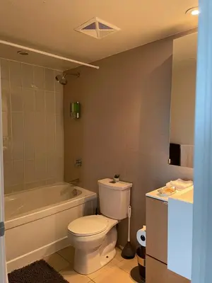 a bathroom with a toilet and a tub and a sink at Toronto Downtown Luxurious Stylish 3 Bedroom 3 Bath 2 Balconies near Rogers Centre lakeview condo in Toronto