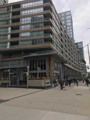 a large building with people walking in front of it at Toronto Downtown Luxurious Stylish 3 Bedroom 3 Bath 2 Balconies near Rogers Centre lakeview condo in Toronto