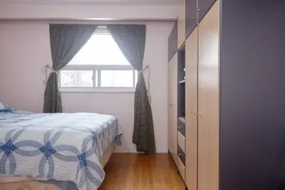a bedroom with a bed and a window at Private Room near Airport in Mississauga