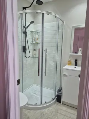 a glass shower in a bathroom with a sink at Private Room near Airport in Mississauga