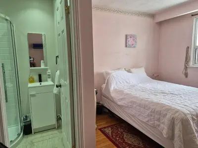 a bedroom with a bed and a walk in shower at Private Room near Airport in Mississauga