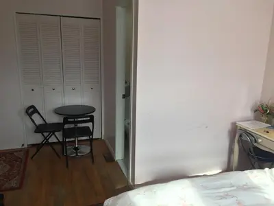 a bedroom with a table and a chair and a bed at Private Room near Airport in Mississauga