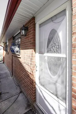 a front door of a brick house with a window at Private Room near Airport in Mississauga