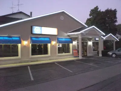 a building with a parking lot in front of it at Howard Johnson by Wyndham Niagara Falls in Niagara Falls