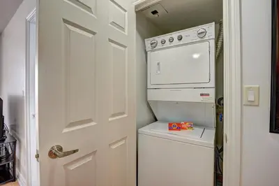 a white washer and dryer in a small kitchen at Bombay Suites Mississauga in Mississauga