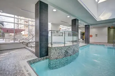 a large swimming pool in a building at Bombay Suites Mississauga in Mississauga