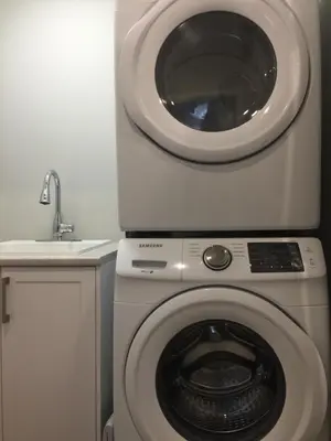 a washing machine and a sink in a bathroom at Charming, Comfortable Bsmt Apartment in Pickering in Pickering