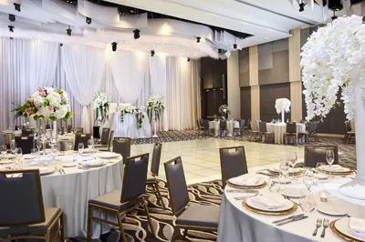 a banquet hall with tables and chairs and flowers at Hyatt Place Toronto Mississauga and Luxe Convention Centre in Mississauga
