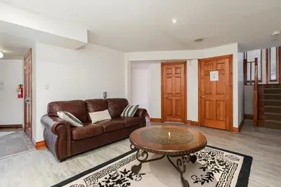 a living room with a couch and a table at Blue Mountain-Luxurious BlueSki George Chalet, Hot Tub, Pool, Gas Fireplace in Blue Mountains
