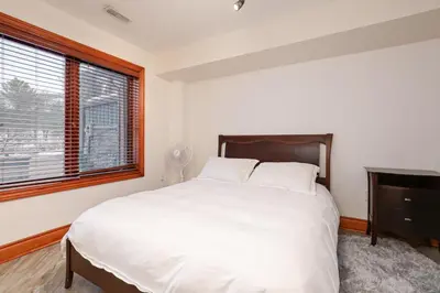 a bedroom with a large white bed and a window at Blue Mountain-Luxurious BlueSki George Chalet, Hot Tub, Pool, Gas Fireplace in Blue Mountains