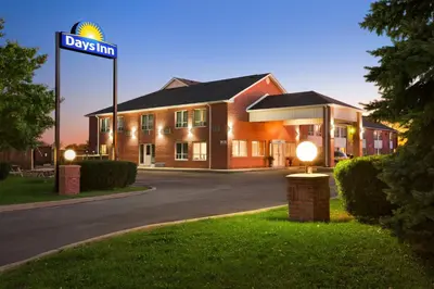 a building with a street sign in front of it at Days Inn by Wyndham Stouffville in Stouffville