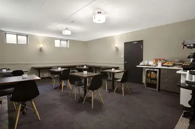 a dining room with tables and chairs and a counter at Days Inn by Wyndham Stouffville in Stouffville