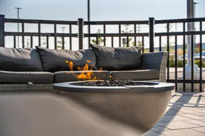 a fire pit sitting in front of a couch at TownePlace Suites by Marriott Brantford and Conference Centre in Brantford